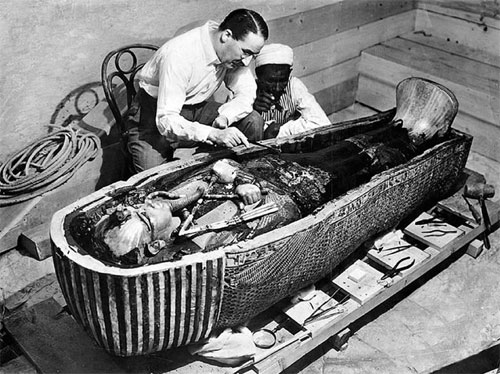 Howard Carter inspecting King Tut's mummy